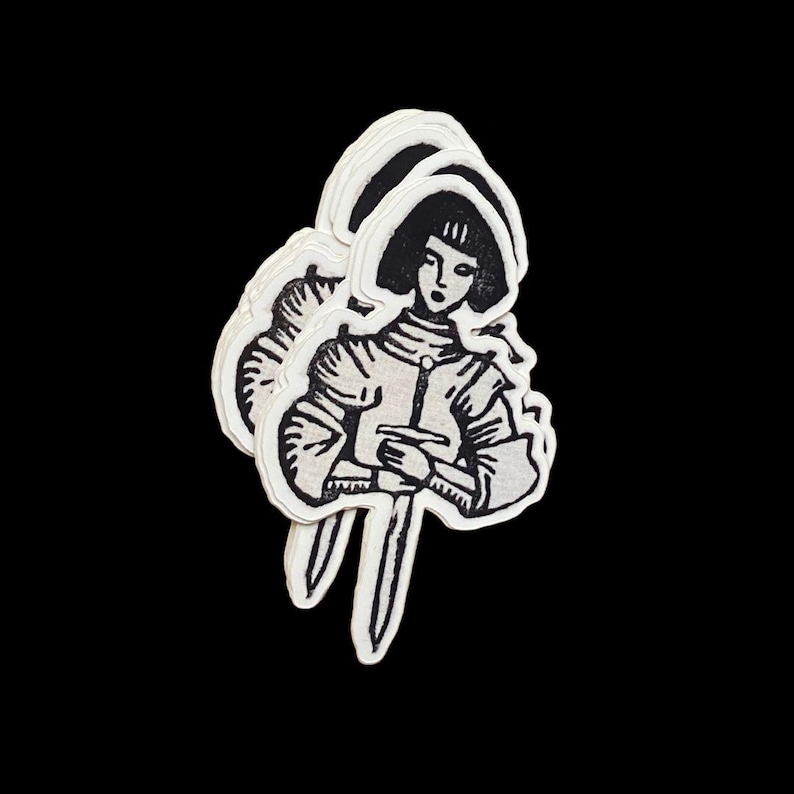 May include: A stack of three stickers featuring a black and white illustration of a person in armor holding a sword. The person has short hair and is facing forward. The stickers have a white border and are set against a black background.