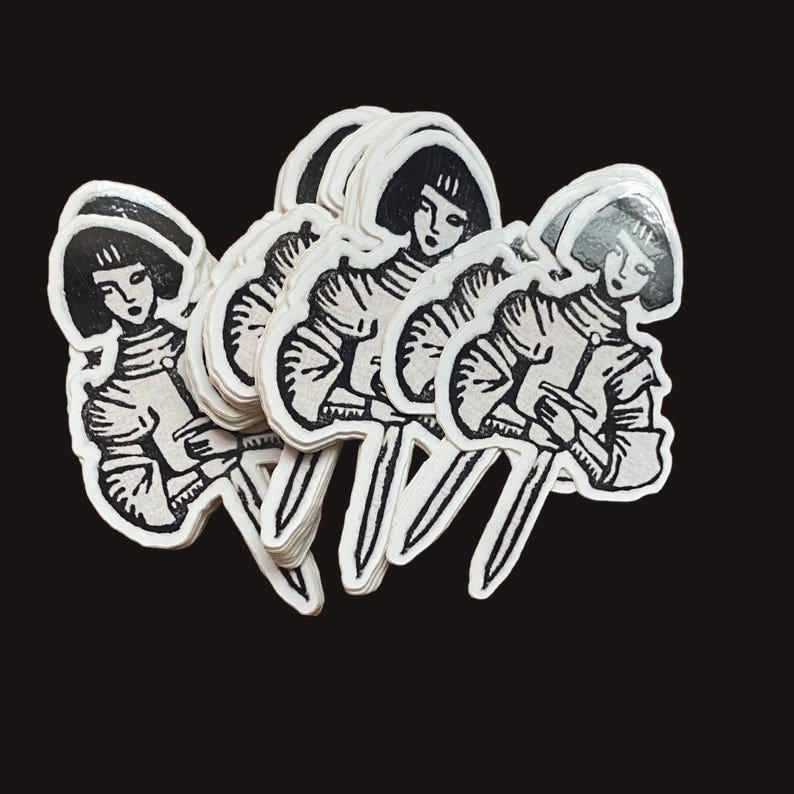May include: A stack of stickers featuring a black and white illustration of a person in medieval armor holding a sword. The stickers have a vintage, hand-drawn aesthetic and are set against a black background.