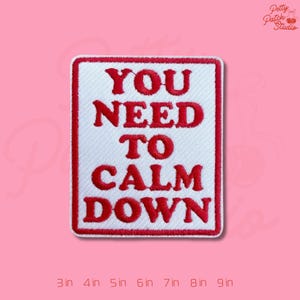 May include: Embroidered patch with the text "YOU NEED TO CALM DOWN" in red on a white background, framed by a red border. The patch is rectangular and set against a pink backdrop. Available in sizes from 3 to 9 inches.