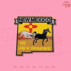 May include: Embroidered patch in the shape of New Mexico, featuring a black horse, a red and yellow sun symbol, and the text "NEW MEXICO" and "LAND OF ENCHANTMENT". The patch measures from 3 to 9 inches.