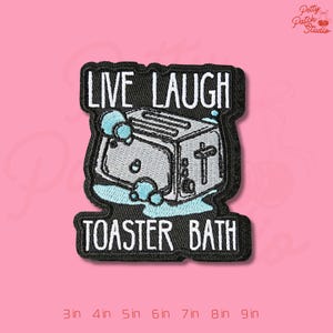 May include: Embroidered patch with a black border and a pink background. The patch features a silver toaster in a bubble bath with the words "LIVE LAUGH TOASTER BATH" in white. The patch measures 3 inches to 9 inches.
