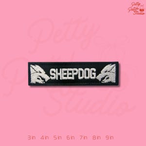 May include: Black rectangular patch with the word "SHEEPDOG" embroidered in white. The patch features a white wolf head on each end. The patch is available in sizes from 3 inches to 9 inches.