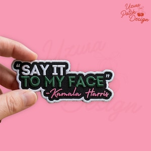 May include: A white ceramic mug with a black handle and the text "But First, Coffee" in a bold, black font. The mug is set against a blurred background, highlighting its clean design.