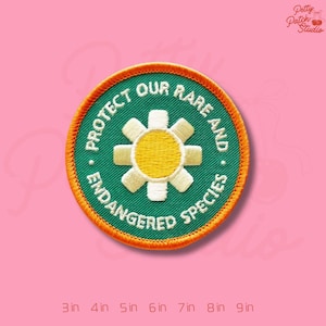 May include: Embroidered patch with the text "PROTECT OUR RARE AND ENDANGERED SPECIES" in white on a green background. The patch features a yellow and white flower design, with an orange border. Sizes range from 3 inches to 9 inches.