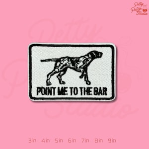 May include: Embroidered patch with a black and white dog silhouette and the text "POINT ME TO THE BAR" on a white background. The patch is rectangular with a black border. Sizes range from 3 to 9 inches.