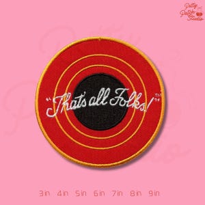 May include: Embroidered patch with a red background and concentric yellow circles. The center features a black circle with the phrase "That's all Folks!" in white script. The patch is round and measures from 3 to 9 inches.