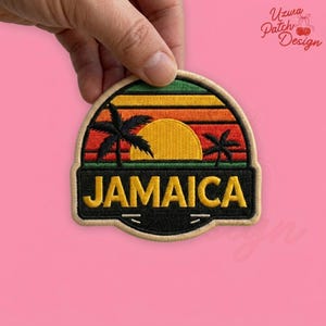 May include: Embroidered patch featuring a sunset scene with palm trees and the word "JAMAICA" in yellow letters. The patch has a black border and a beige background. The design includes green, orange, and yellow colors.