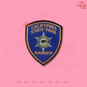 May include: A blue and gold embroidered patch featuring the words "CALIFORNIA STATE PARK RANGER". The patch has a shield shape with a central emblem of a bear inside a star. The patch is available in sizes from 3 to 9 inches.
