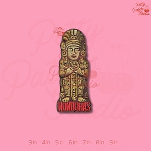 May include: Embroidered patch featuring a gold-colored Mayan statue with the word "HONDURAS" in red at the base. The patch is approximately 3 inches tall and is set against a pink background. The patch is from Petty Patch Studio.