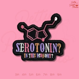 May include: Embroidered black patch featuring a serotonin molecule design in pink and white, with the text "SEROTONIN? IN THIS ECONOMY?" in colorful letters. The patch is available in sizes from 3 to 9 inches.