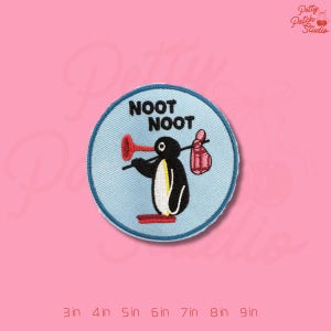 May include: Embroidered patch featuring a penguin character with the text "NOOT NOOT". The penguin is holding a plunger and a bag. The patch is round with a light blue background and a dark blue border. The patch is 3 inches to 9 inches in size.
