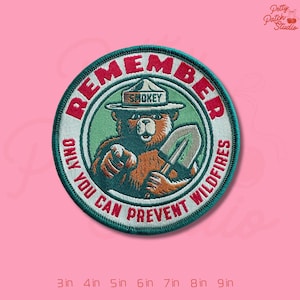 May include: Embroidered patch featuring Smokey Bear, a bear wearing a ranger hat, holding a shovel, and pointing. The patch reads "REMEMBER, ONLY YOU CAN PREVENT WILDFIRES." The patch is round with a green and red color scheme. Available in sizes from 3 inches to 9 inches.