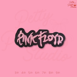 May include: A black embroidered patch with the words "PINK FLOYD" in pink thread. The patch is rectangular with a black border and is displayed on a pink background. The patch measures 3 inches to 9 inches.