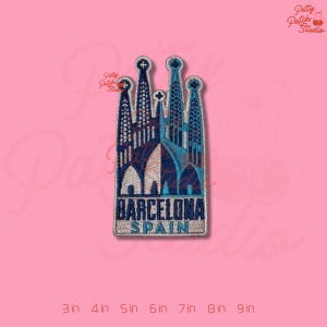 May include: Embroidered patch featuring the Sagrada Familia in Barcelona, Spain. The patch is rectangular with a detailed depiction of the cathedral in shades of blue, white, and brown. The text "BARCELONA SPAIN" is at the bottom.