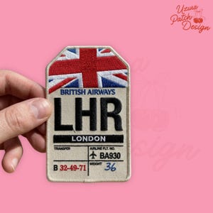 May include: A rectangular patch featuring the Union Jack flag at the top, with the text "BRITISH AIRWAYS" above the letters "LHR" and "LONDON". The patch includes the text "TRANSFER", "AIRLINE FLT. NO. BA930", and "WEIGHT 36".