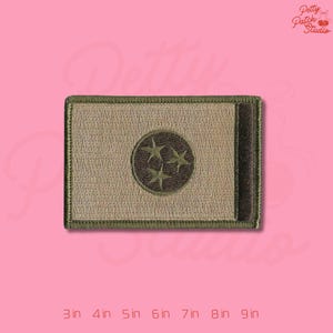 May include: Embroidered patch featuring the Tennessee state flag design. The patch has a rectangular shape with a tan background, a dark brown vertical stripe, and a circular emblem with three stars. The patch is available in sizes from 3 to 9 inches.