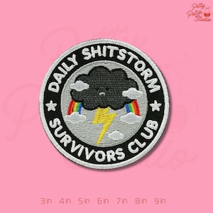 May include: Embroidered patch with the text "DAILY SHITSTORM SURVIVORS CLUB" in white on a black circular background. The design includes a black cloud, rainbow, and yellow lightning bolt. Patch sizes range from 3 to 9 inches.