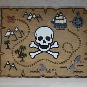 May include: Wooden pirate treasure map with a skull and crossbones, a ship, mountains, palm trees, and shark fins. The map is in shades of brown, with white, black, and gray accents. The map has a compass rose and an "X" marking the spot.