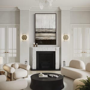 May include: A contemporary living room with a black fireplace, white walls, and an abstract painting. The room features cream sofas and chairs, a black coffee table, and a decorative chandelier. The floor is covered with a white rug.