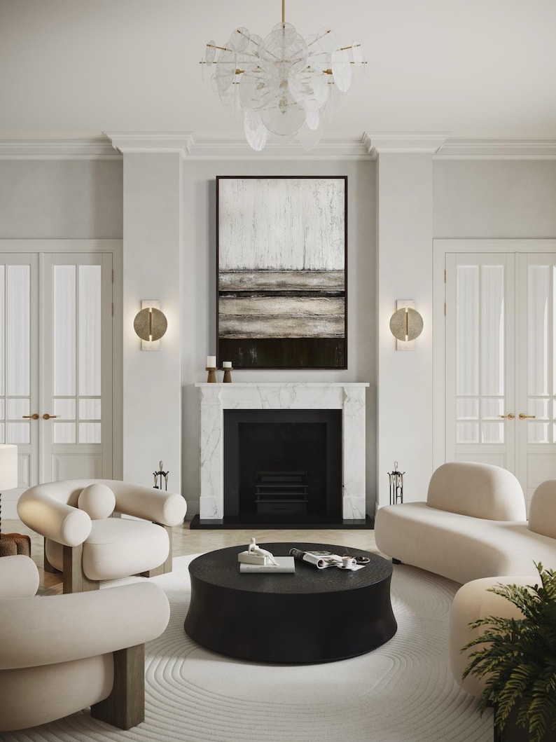 May include: A contemporary living room with a black fireplace, white walls, and an abstract painting. The room features cream sofas and chairs, a black coffee table, and a decorative chandelier. The floor is covered with a white rug.