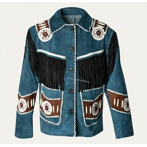 May include: A teal suede jacket featuring long black fringe across the chest, brown leather panels on the sleeves and lower front, white braided trim, and circular beaded medallions with white and brown accents. The jacket has a button-up front.