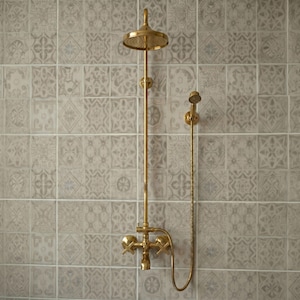 May include: A wall-mounted brass shower system featuring a circular overhead shower head, a vertical pipe, a handheld shower attachment with a flexible hose, and two cross-handle valves for controlling water flow and temperature.