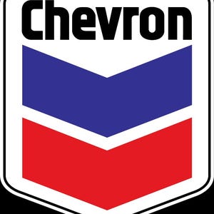 May include: Chevron logo in a white-bordered shield shape. The logo features a bold black "Chevron" text above a blue and red chevron design. The design is a classic symbol associated with the oil and gas industry.