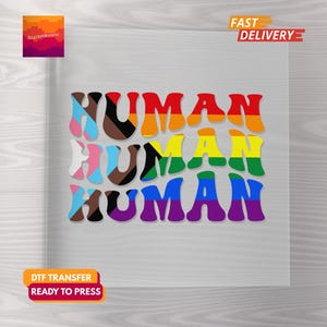 Puede incluir: Un diseño gráfico colorido con la palabra "HUMAN" repetida tres veces en colores arcoíris. El diseño está sobre una superficie cuadrada transparente, con el texto "FAST DELIVERY" y "DTF TRANSFER READY TO PRESS".