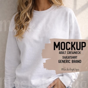 May include: A white adult crewneck sweatshirt mockup. The image includes the text "MOCKUP", "ADULT CREWNECK", "SWEATSHIRT", and "GENERIC BRAND". The sweatshirt is plain and has a round neckline. The brand name "MocksbyKiya" is also visible.