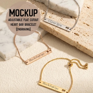 May include: Three adjustable flat cutout heart bar bracelets in silver, rose gold, and gold. Each bracelet features a rectangular bar with a heart-shaped cutout and engraved text. One reads "I Love You", and two read "MocksbyKiya".