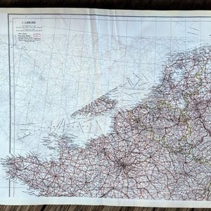 May include: A vintage map showing a detailed network of roads and cities, printed on aged paper. The map has a scale of 1:2,000,000 and includes text in the upper left corner. The map is folded and has a cream border.