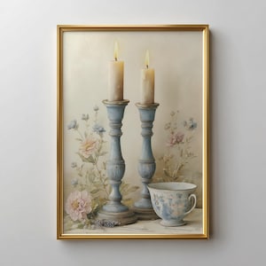 May include: A framed print featuring two lit candles atop light blue candle holders. The artwork includes a teacup and floral accents in pink and blue, set against a soft, neutral background. The frame is gold.
