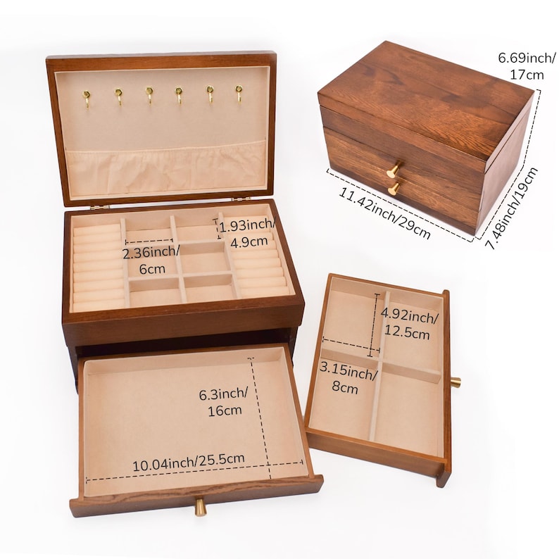 May include: A wooden jewelry box with multiple compartments and drawers. The box is brown with a light beige interior. Dimensions are provided in inches and centimeters, including a 11.42-inch (29 cm) long box.