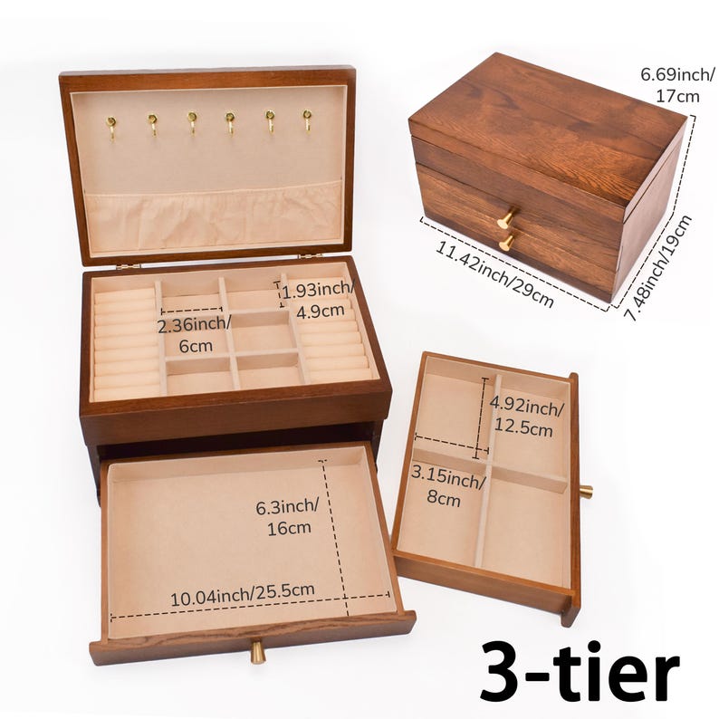 May include: A 3-tier wooden jewelry box with a dark brown finish. The box has multiple compartments and drawers, including ring holders and storage spaces. Dimensions are provided in inches and centimeters.