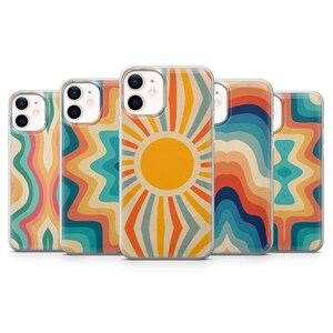 May include: A collection of five phone cases with retro-style designs. The cases feature vibrant patterns including a sunburst, wavy lines, and geometric shapes in shades of orange, yellow, blue, and pink. Each case has a clear border.