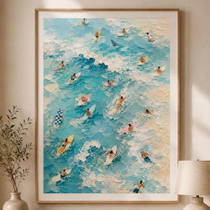 May include: A framed wall art print featuring an aerial view of a textured oil painting depicting numerous surfers on colorful surfboards in blue ocean waves with white foam, rendered with thick impasto brushstrokes and a vibrant color palette.
