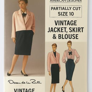 May include: Vogue Patterns sewing pattern for a vintage jacket, skirt, and blouse, designed by Oscar de la Renta. The pattern is partially cut and size 10. The cover features a woman wearing the ensemble in a pink jacket and black skirt.