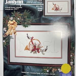 May include: A counted cross stitch pattern for a Christmas design featuring the word "Noel" in white with a red ribbon and two blue birds. The finished size is 14 inches by 9 inches. The pattern includes 14-count Aida fabric, pre-sorted 6-strand cotton floss, a needle, a graph, and instructions.