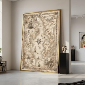 May include: A large framed vintage map with a gold frame. The map features detailed illustrations of ships, islands, and a compass rose. The artwork is displayed against a white wall in a well-lit room.