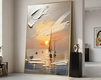 May include: Large framed oil painting of a sunset over the ocean with sailboats. The artwork features textured brushstrokes, a golden frame, and a warm color palette of orange, yellow, and blue.