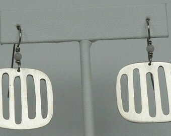 Handcrafted sterling silver earrings with a pierced geometrical design.