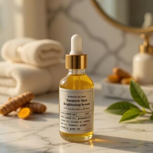 May include: A clear glass bottle of Turmeric Skin Brightening Serum with a gold cap and white dropper. The label reads "Enchanted Sea Nymph" and "100% handmade with love." The bottle is on a marble surface, with turmeric roots and a green leaf in the background.
