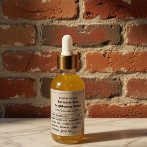 May include: A clear glass bottle of Turmeric Skin Brightening Serum with a white and gold dropper. The label lists ingredients like sweet almond oil and vitamin E. The bottle is on a marble surface with a brick wall background.