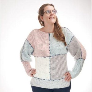 May include: A long-sleeved sweater featuring a patchwork design of large, rectangular knit panels in soft pastel shades of pink, light blue, and cream. The panels are joined together with visible dark blue cross-stitch detailing throughout.