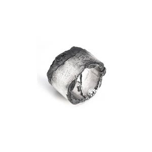 Puede incluir: Un anillo ancho de plata texturizada con un borde superior oscuro y rugoso. El anillo tiene una apariencia orgánica, casi de corteza, con una superficie rugosa e irregular. El diseño es audaz y moderno, adecuado para el uso diario.