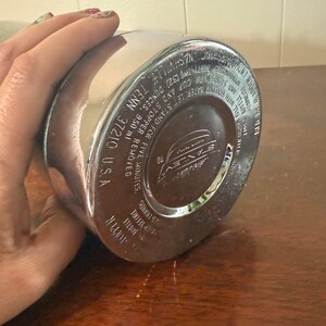 Puede incluir: Termo de metal plateado con un logotipo en blanco y negro que dice "Savlev". El termo tiene instrucciones de uso impresas en la parte inferior, incluyendo "Dejar reposar durante cinco minutos, quitar el tap&oacute;n y verter".