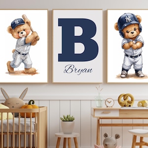 May include: Three framed prints with a baseball theme. Two show a teddy bear in a baseball uniform, one batting and the other ready to play. The third print has a large navy blue "B" with the name "Bryan" below.