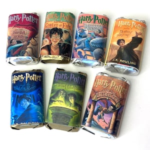 May include: Seven candy bars wrapped in foil, each featuring a different cover from the Harry Potter book series. The covers display illustrations and titles like "Chamber of Secrets" and "Goblet of Fire". The J.K. Rowling book "Deathly Hallows" is also visible.