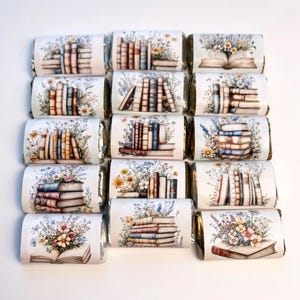 May include: Sixteen chocolate bars with floral and book-themed wrappers. The wrappers feature watercolor illustrations of stacks of books, open books, and wildflowers in various arrangements. The color palette includes blues, browns, and greens.
