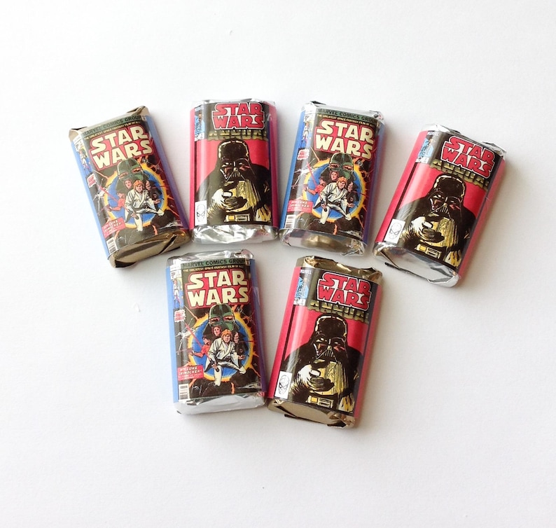 May include: Six candy bars with wrappers designed as vintage Star Wars comic book covers. The wrappers show Darth Vader and other characters, with the Star Wars logo. The wrappers are in red, blue, and silver.